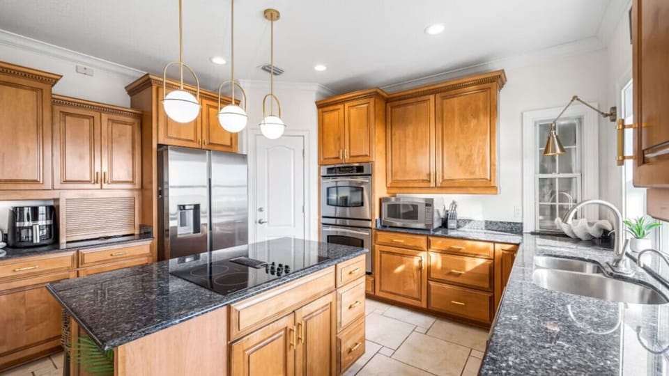 Your spacious kitchen features beautiful wood cabinets, granite countertops, and top-tier appliances for memorable meal prep during your stay.
