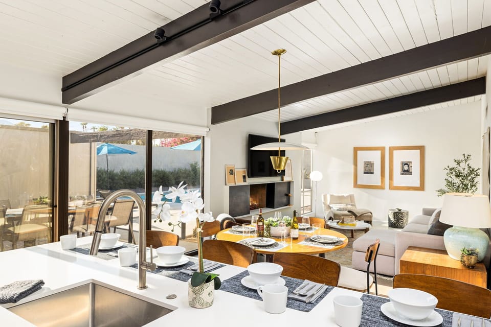 Take in both indoor comfort and outdoor views from the kitchen, seamlessly connected to the open-concept dining and living space.  Please note that fireplace is not operational for guest use.