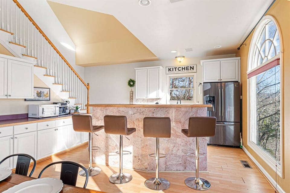 Kitchen: Stylish bar seating invites laughter and good times as you whip up culinary delights!