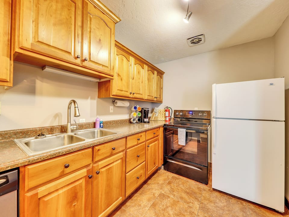 Kitchen Cabinetry, Stainless Steel Sink & Faucet, Microwave, Dishwasher, Keurig Coffee Maker, Knife Block, Stove, Refrigerator