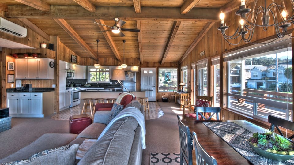 Sand Pads Living and Dining Area - Living and dining area showing kitchen counter and second floor entry.