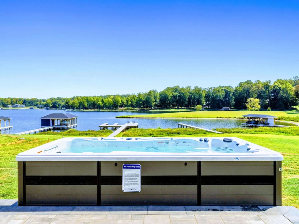 Hot tub - A lakefront swim spa with panoramic water views, ready for a soak at any hour of the day.