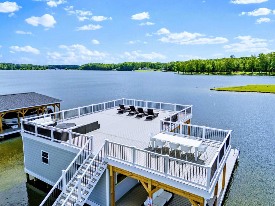 Backyard - From above, the house and custom boathouse line up along your private shoreline, with the lake opening wide beyond.