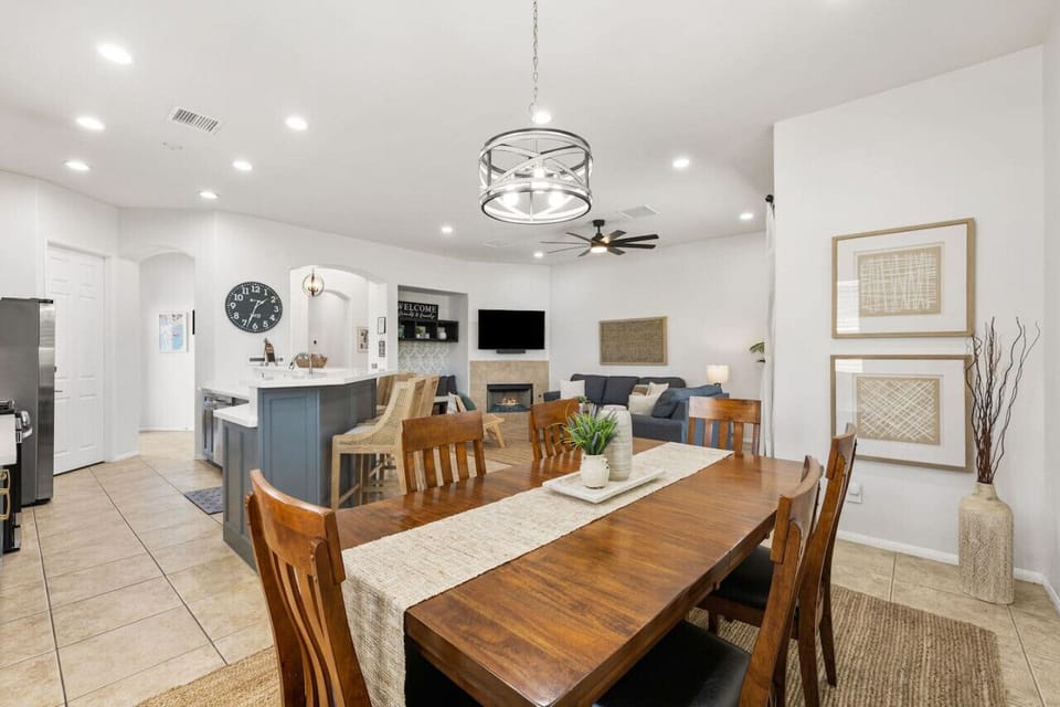 Open dining area w/ modern chandelier & large table made for shared meals together.
