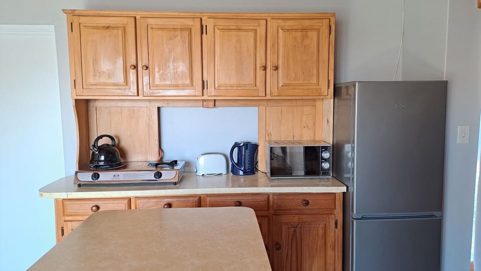 Apartment, Patio, Garden Area | Private kitchen | Full-size fridge, microwave, toaster, cookware/dishes/utensils