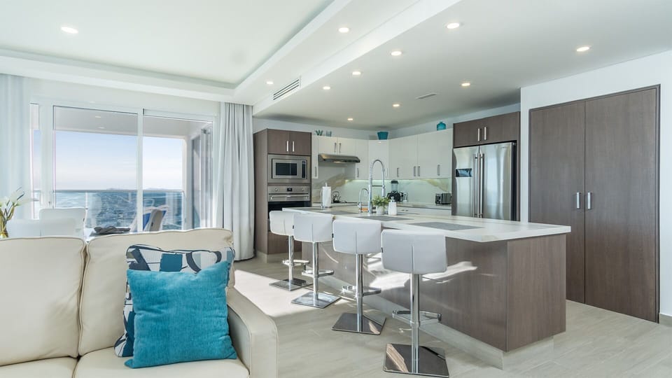 The kitchen counter with raised bar stools