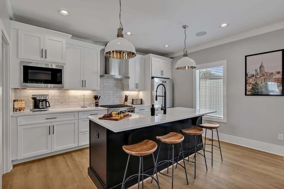 2nd Floor: Fully equipped kitchen, complete with all essential culinary tools, boasts stainless-steel appliances and a spacious island with ample counter space and bar seating.