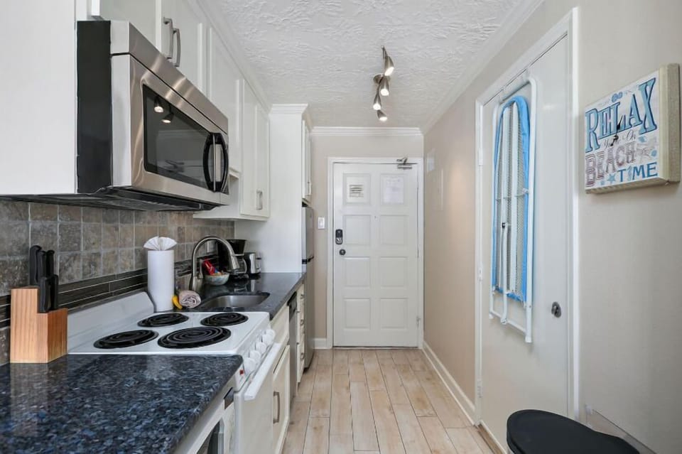 Small and efficient kitchen. Equipped with pots, pans, dishes coffee maker, and toaster.