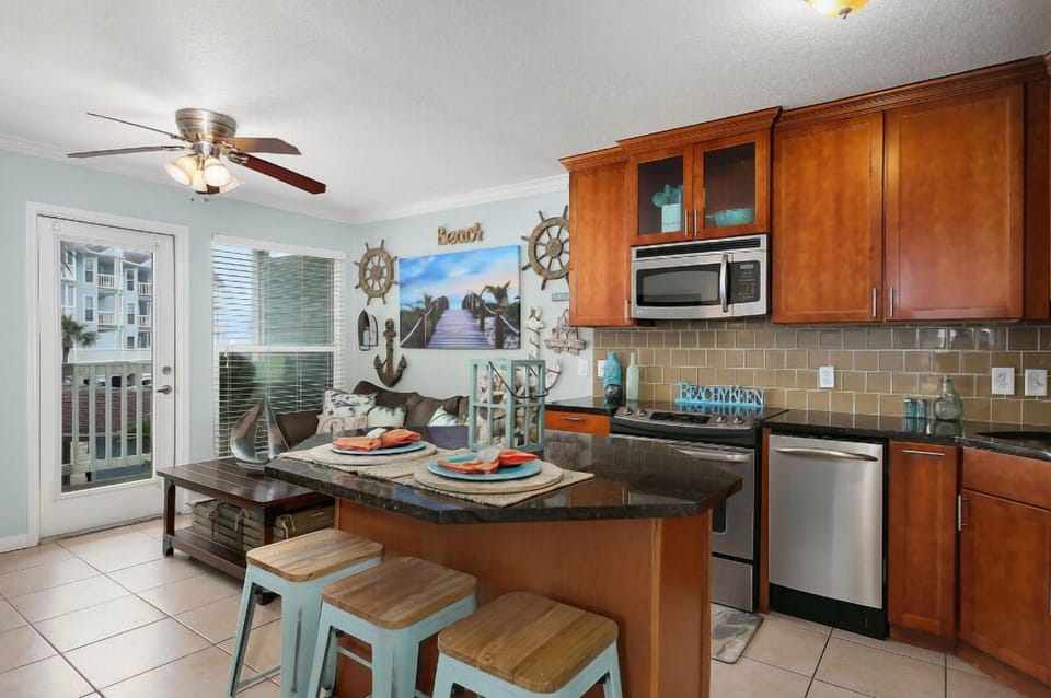 Fully equipped Kitchen opens up to the living space.  Bar seating, with an additional dining area on the big covered balcony.