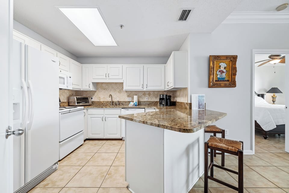 Full size kitchen stocked with basic cooking essentials