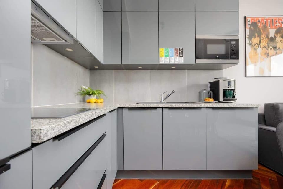 A close-up of the kitchen's cooking area, featuring a modern induction hob and plenty of counter space. Bright and clean with stylish finishes.