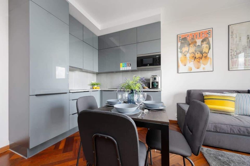 A sleek and modern kitchen with gray cabinets, wooden floors, and full amenities. Perfect for cooking your favorite meals.