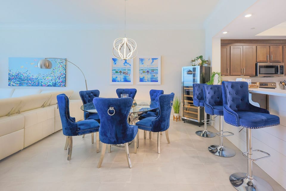 Sink into plush blue chairs at the glass table and grab a chilled bottle from the wine fridge