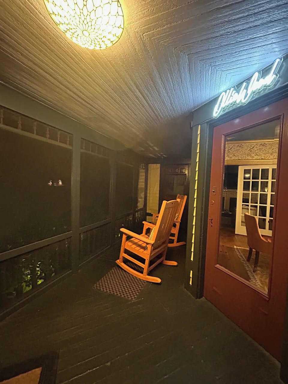 Rocking chairs at night on front porch surrounded by beautiful foliage!