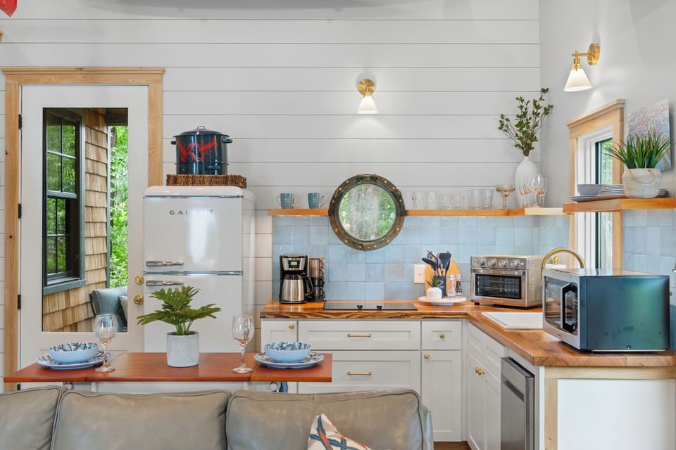 Enjoy a beautifully crafted kitchen with warm wood accents and nautical touches.