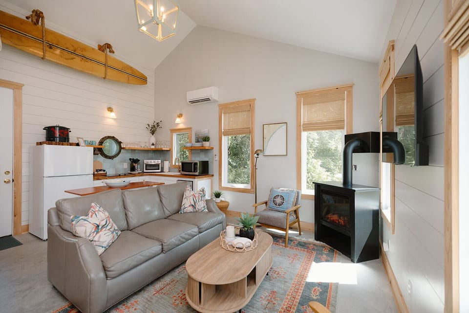 Cozy, open-concept living space with a fireplace and coastal décor. 