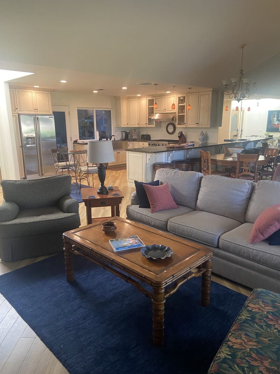 Living room with sofa, two lounge chairs, recliner, and large smart TV