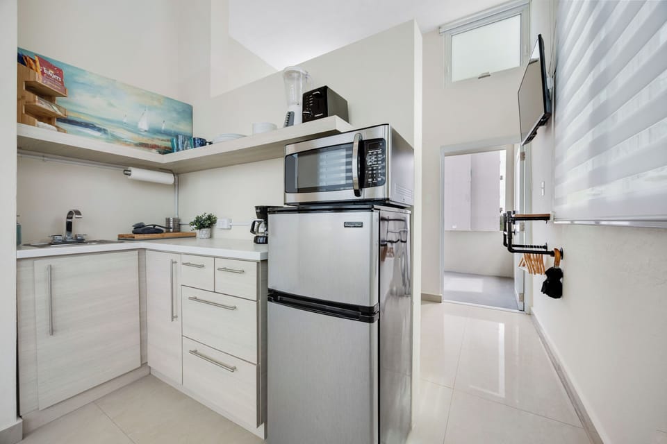 Fully stocked kitchenette. Door leading to your private balcony.