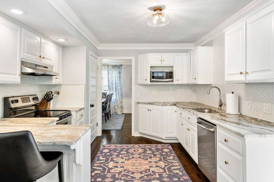 The kitchen is situated between the two dining room tables, for plenty of seating and room to cook up a feast.