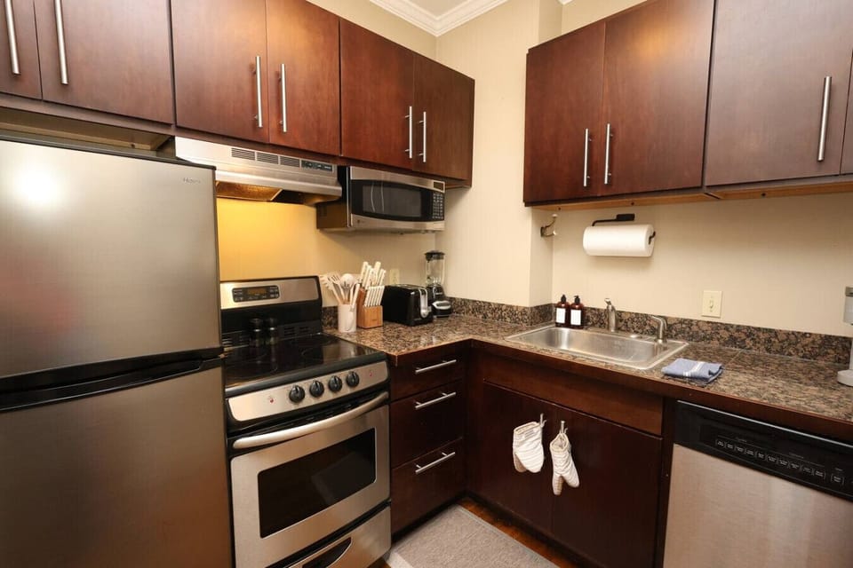 Kitchen: Stylish appliances and rich wood accents await culinary adventures in this fully equipped space!
