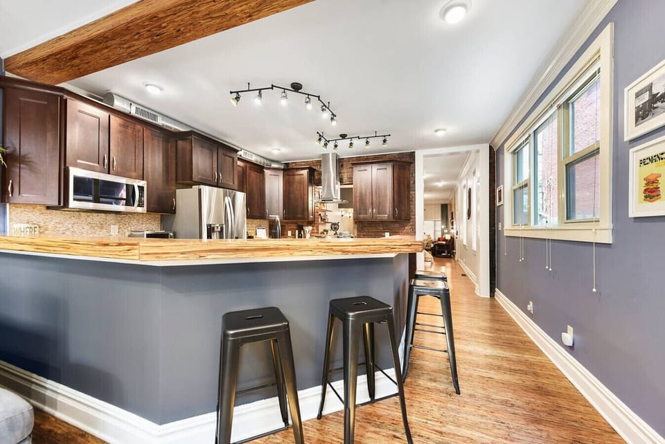 Modern kitchen with stylish bar seating, perfect for casual meals or enjoying your morning coffee.