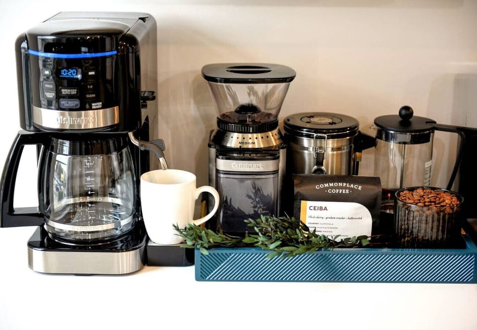 Start your morning with freshly brewed coffee from the well-stocked coffee bar featuring a coffee maker, grinder, and premium beans.