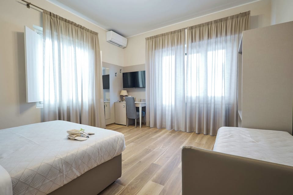 Deluxe Quadruple Room, Multiple Beds | Minibar, desk, laptop workspace, free WiFi