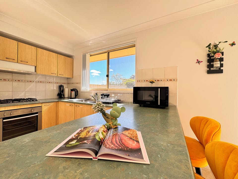 The fantastic kitchen is fully equipped with essential appliances.