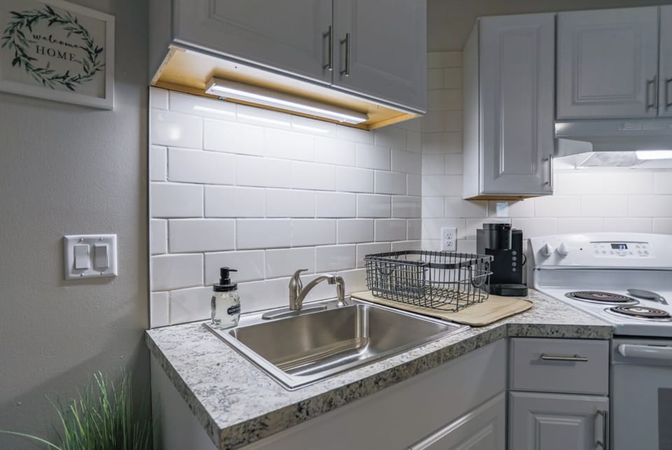 A modern kitchen equipped with high-end appliances and ample lighting.