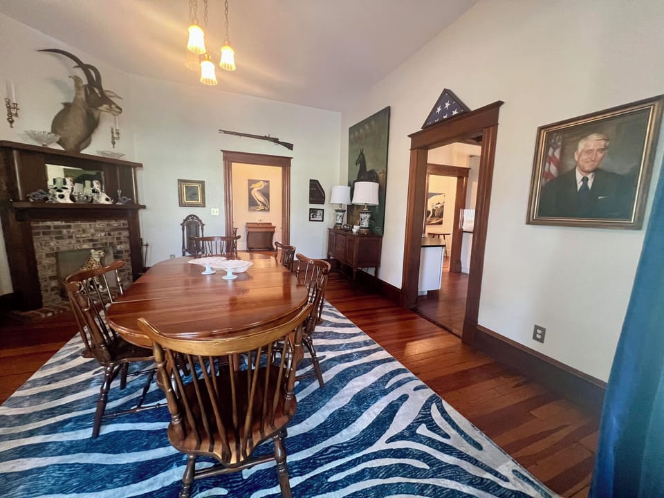 formal dining room opens to formal living room on one side and kitchen on other