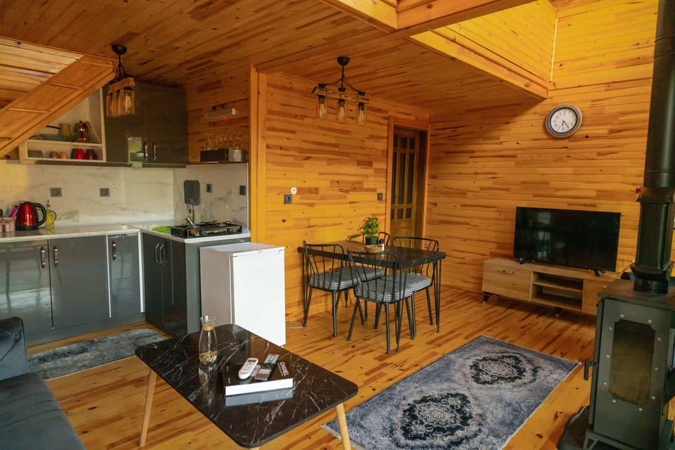 Deluxe Cottage | Living area | Flat-screen TV, toys