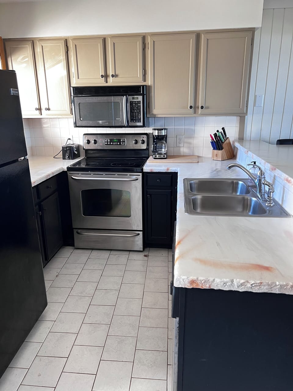 Kitchen with flat top electric range and dishwasher