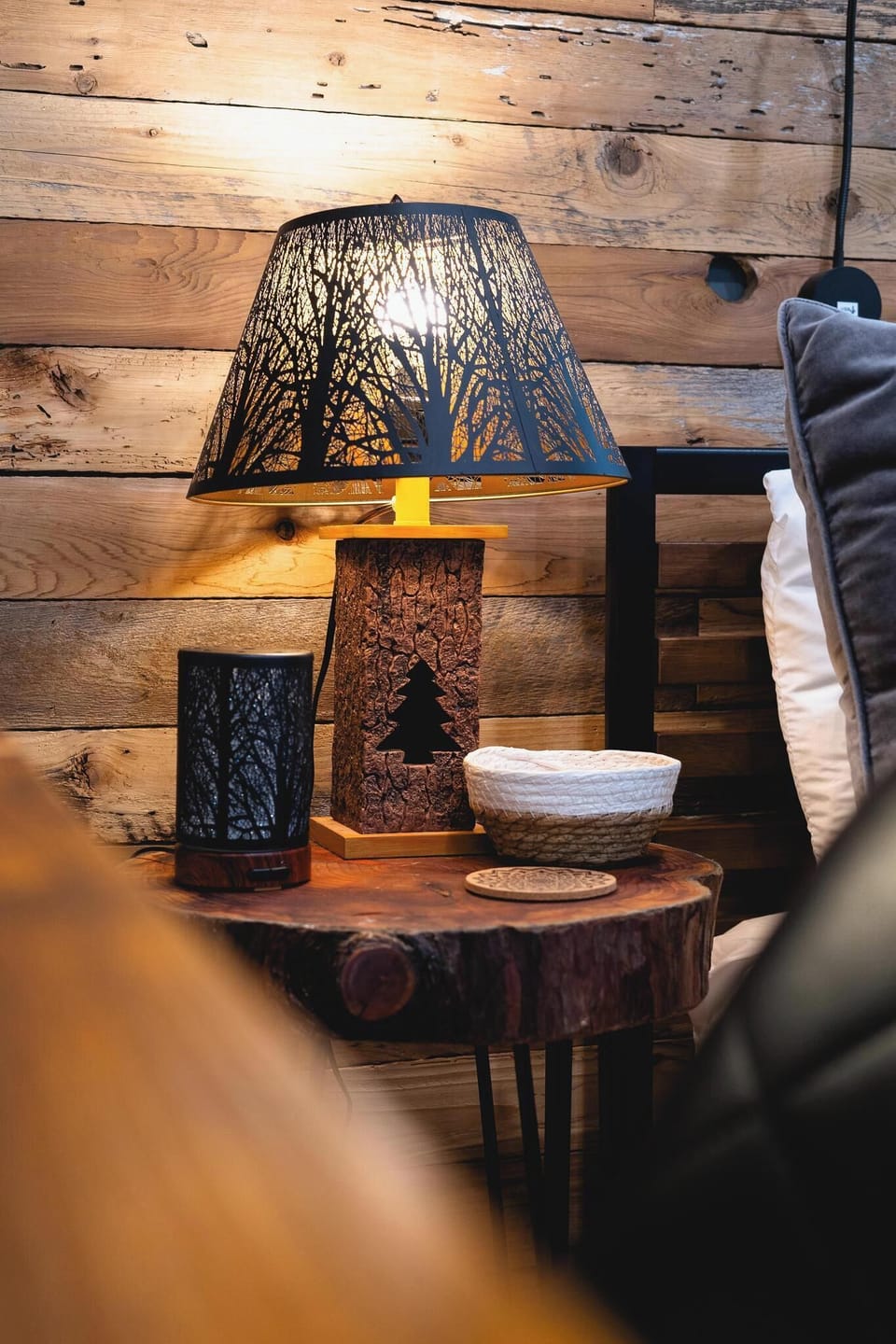 - Rustic nightstand with woodland themed lamp and decor  
- Warm wood tones and natural textures create cozy design  
- Charming details that highlight a forest-inspired style  
