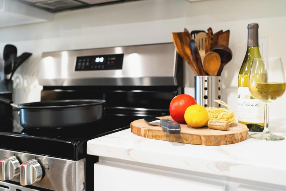 - Modern stove with fresh produce and kitchen utensils ready  
- Sleek countertop design perfect for preparing homemade meals  
- Ideal cooking space for family dinners or group gatherings  
