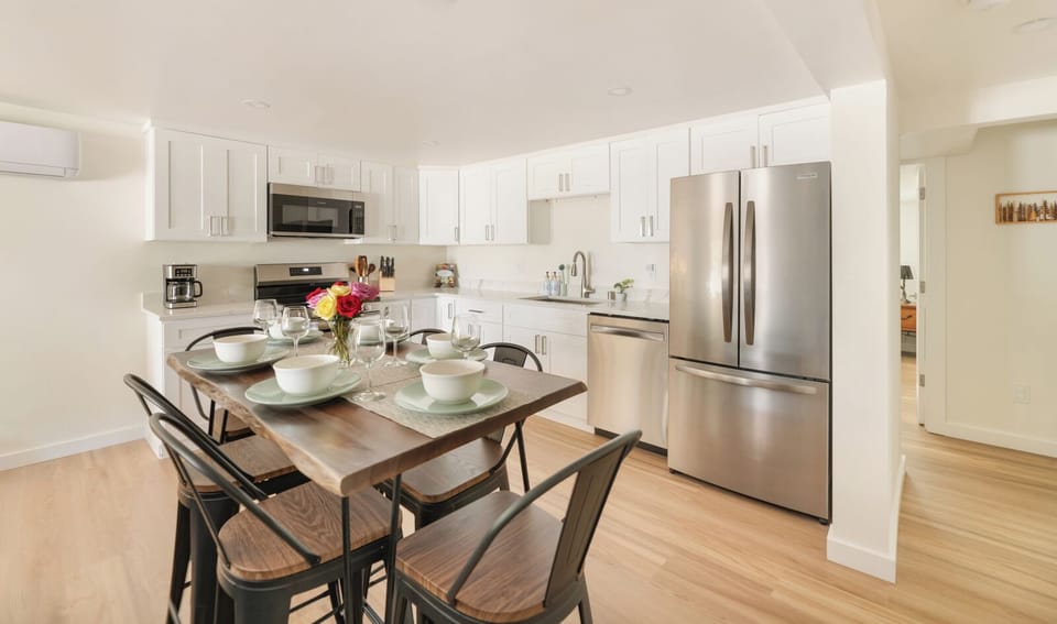 - Fully equipped kitchen with stainless steel appliances  
- Spacious dining table set for shared meals and gatherings  
- Bright open-plan design for cooking and enjoying together  
