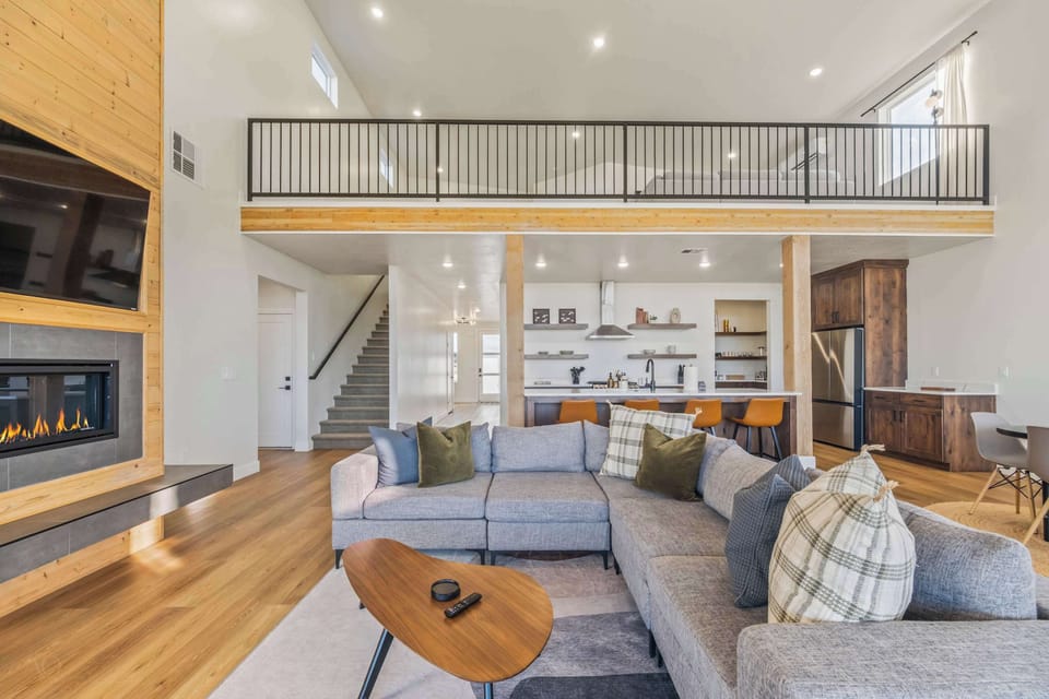 Spacious modern cabin with loft, fireplace, and open-concept living perfect for group gatherings.
