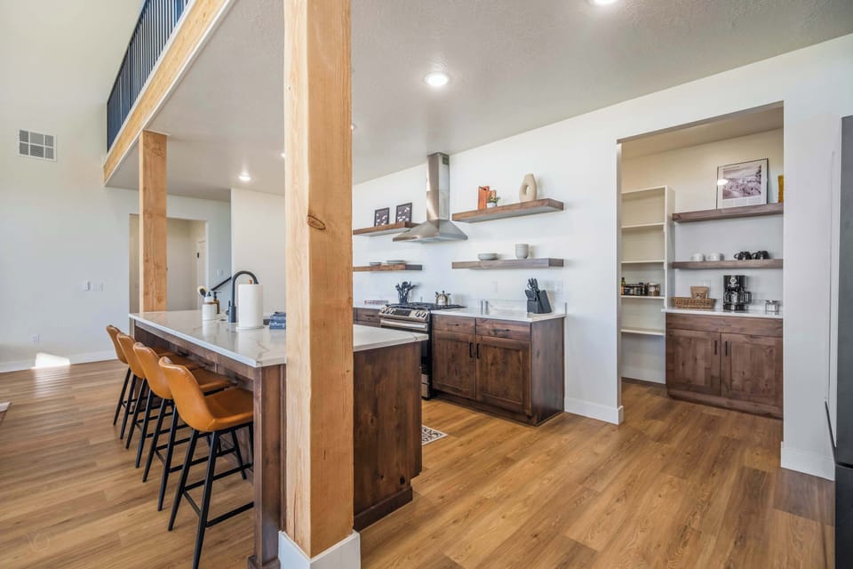 Spacious open-concept kitchen with island seating—perfect for group meals & connection.