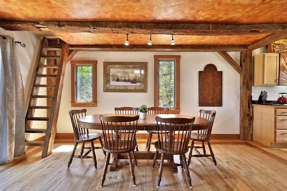 The dining table sits beside the kitchen for simple serving and relaxed meals together.