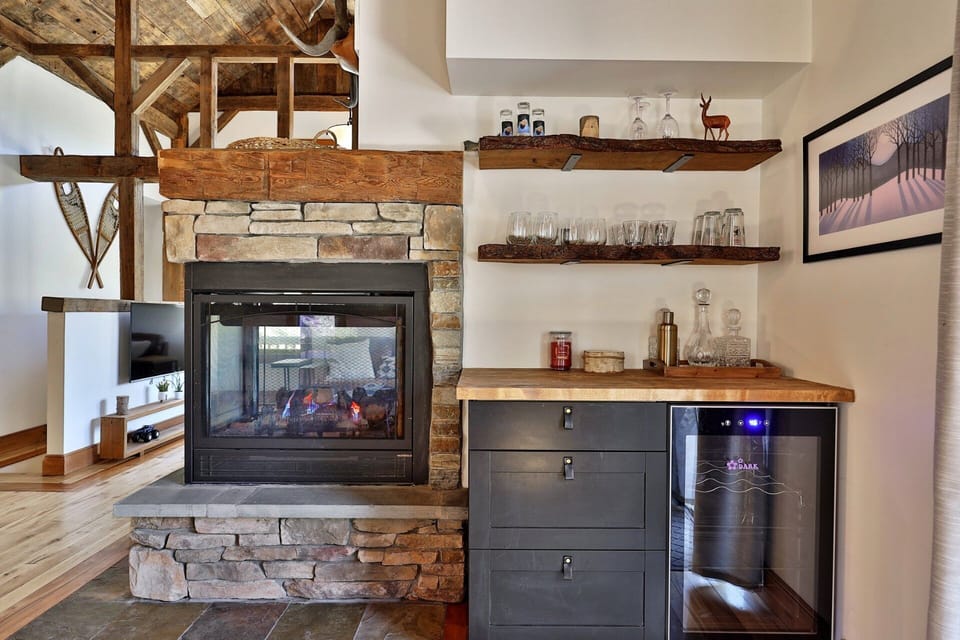 Pour a drink at the compact beverage station beside the fireplace before settling into the living room.
