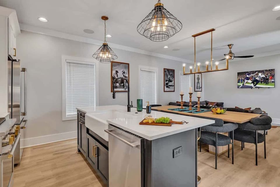 2nd Floor: Fully equipped kitchen stocked with all culinary essentials featuring Monogram stainless-steel appliances, a large kitchen island offering bar seating.