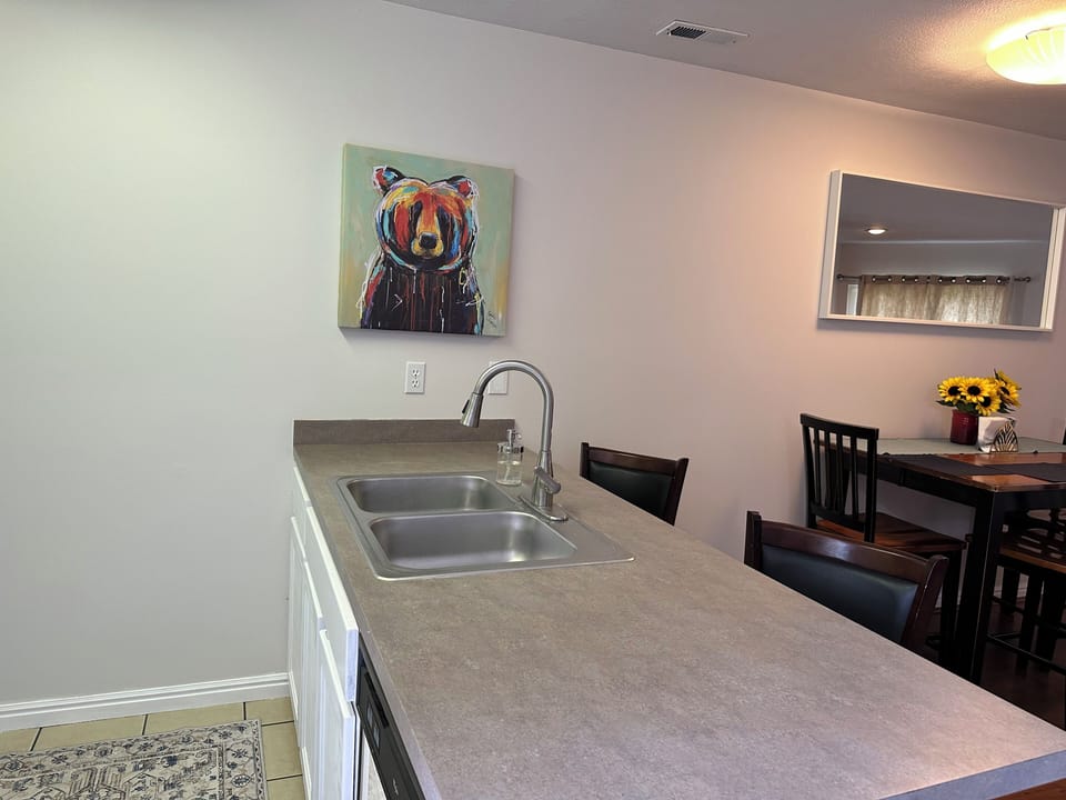 Kitchen island and sink. Two swivel barstools for seating.