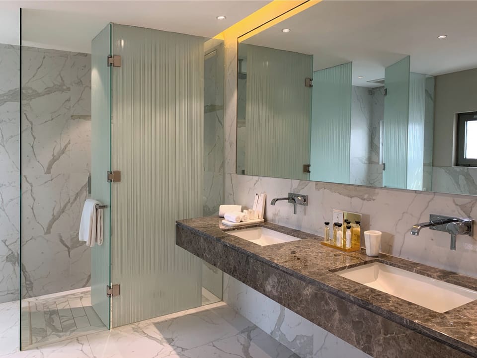 Separate tub and shower, rainfall showerhead, free toiletries