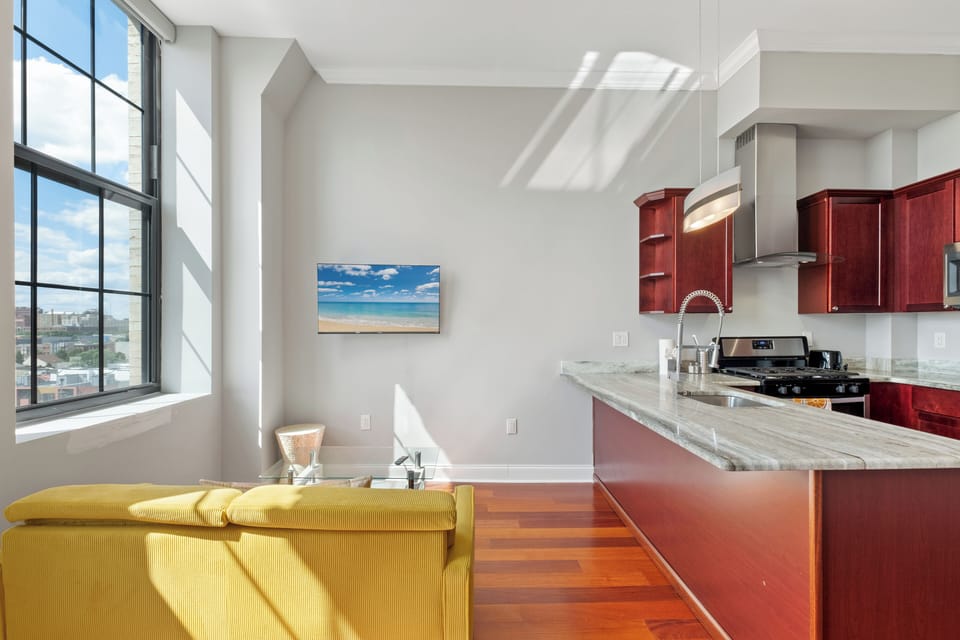 Kitchen featuring cherry wood cabinets, granite countertops, complete cookware and utensils for meal preparation.