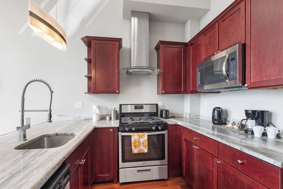  Kitchen workspace with stainless appliances and ample counter space keeping everything organized.