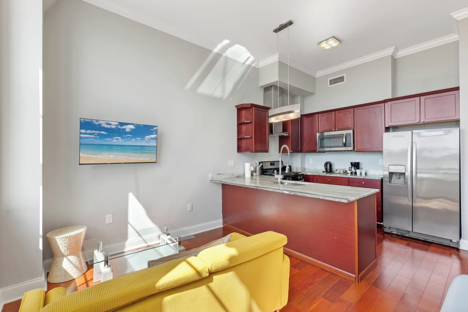 Fully-equipped kitchen with cherry wood cabinets, stainless appliances, and cozy breakfast nook ideal for preparing home-cooked meals.