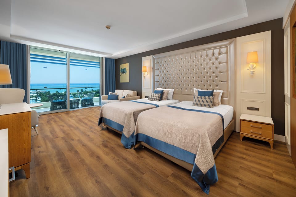 Deluxe Room, Sea View | Free minibar, in-room safe, desk, laptop workspace