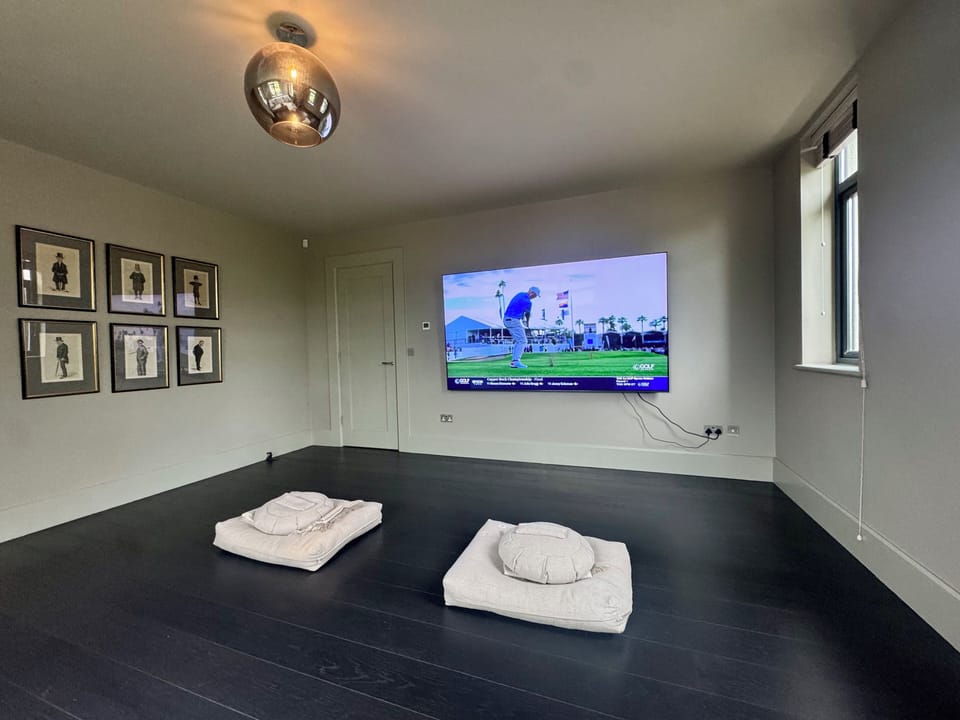 Dedicated Cinema Room with 98-Inch TV for Ultimate Relaxation