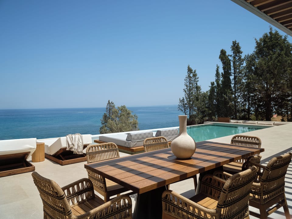 The villa outdoor pool settings, featuring swim up sun-beds.