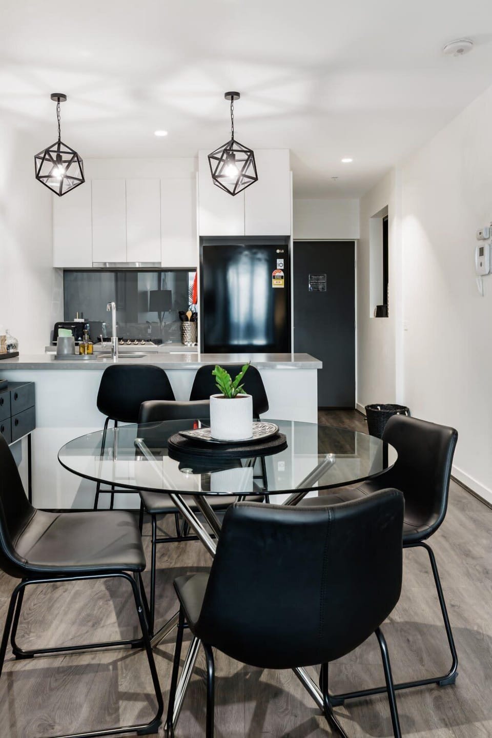 Open plan dining area with seating for four, pendant lighting, and direct flow to the kitchen, ideal for meals and gatherings