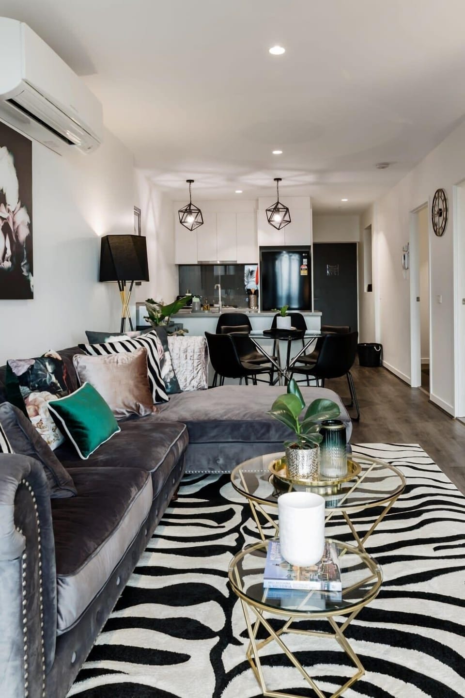 Modern open layout with cozy lounge, dining area, and kitchen, perfect for relaxing and entertaining